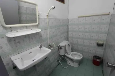 a bathroom with a sink and a toilet and a mirror at Lux Guesthouse in Phi Phi Don