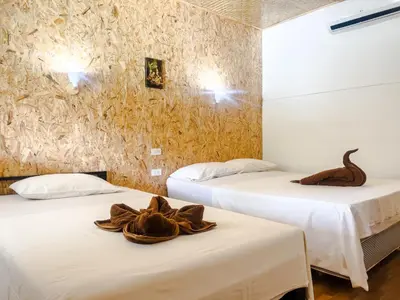two beds in a room with animal sculptures on them at Lux Guesthouse in Phi Phi Don