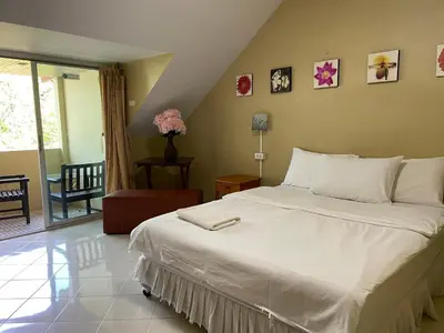 a bedroom with a large white bed in a room at Nawaporn Place in Phuket Town