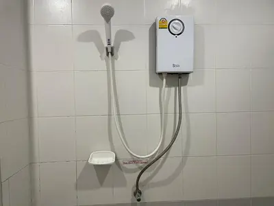 a shower in a bathroom with a blow dryer at Nawaporn Place in Phuket Town