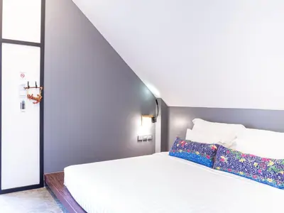 a bedroom with a white bed and a staircase at Deevana Krabi Resort in Ao Nang Beach