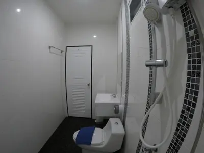 a small bathroom with a toilet and a sink at Phuket Best Travel in Nai Yang Beach