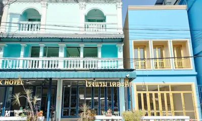 a blue building with akriti hotel on the street at The Duck in Phuket Town