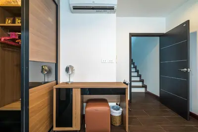 a home office with a desk and a door at AP Grand Residence by Lofty in Kamala Beach