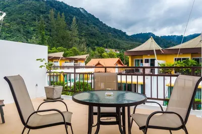a patio with a table and chairs on a balcony at AP Grand Residence by Lofty in Kamala Beach