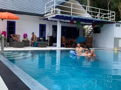 a group of people in a swimming pool at Phuket Gay Homestay in Kathu