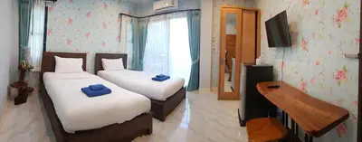 a bedroom with two beds with blue pillows on them at Krabi Lighthouse @ Aonang in Ao Nang Beach
