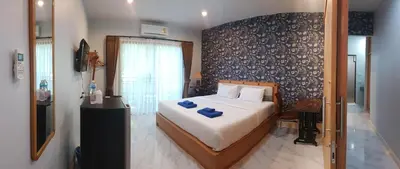 a bedroom with a bed with blue towels on it at Krabi Lighthouse @ Aonang in Ao Nang Beach