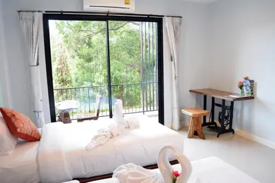 a room with two beds and a large window at Krabi Lighthouse @ Aonang in Ao Nang Beach