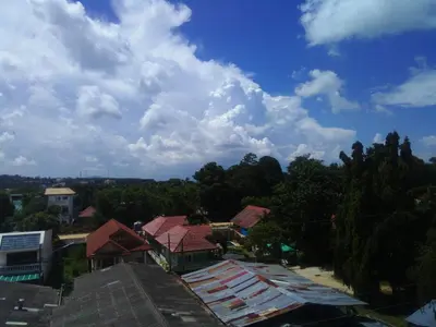 a view of roofs of houses with a cloudy sky at Rawai Condotel 3 in Rawai Beach