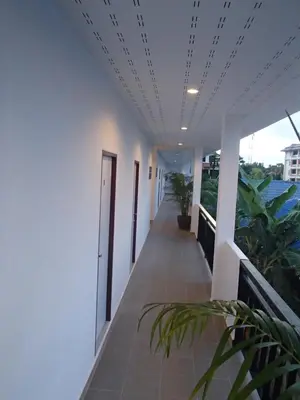 a corridor of a building with plants on it at Coconoi Residence in Nai Harn Beach