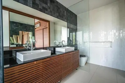 a bathroom with two sinks and a mirror at The Quarter by Lofty in Surin Beach