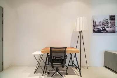 a desk with a chair and a lamp in a room at The Quarter by Lofty in Surin Beach