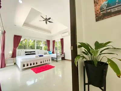 a bedroom with a white bed and a potted plant at Chalong - 4 Bedroom Private Pool Villa - Phuket in Chalong