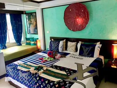 a bedroom with a bed with a blue wall at Casa E Mare in Kata Beach