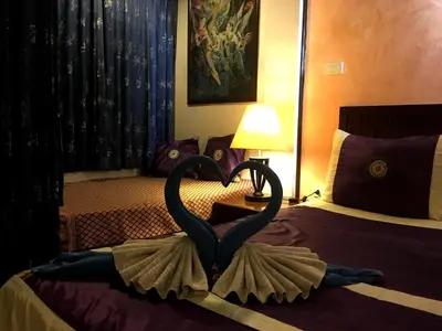 a sculpture of a swan on a bed in a hotel room at Casa E Mare in Kata Beach