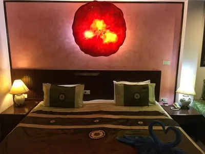 a bedroom with a large red flower on the wall at Casa E Mare in Kata Beach