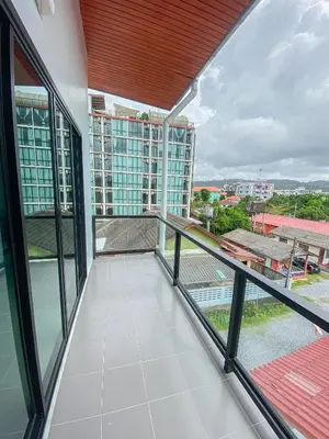 a balcony with a view of a building at S2 Airport Residence in Nai Yang Beach