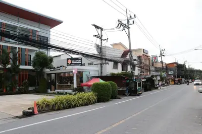 a city street with cars driving down the street at S2 Airport Residence in Nai Yang Beach