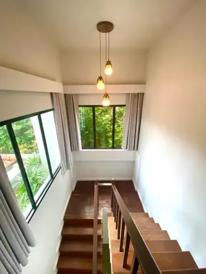 a room with stairs and a large window at The Retreat Ao nang Private Pool Villa in Ao Nang Beach