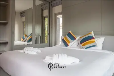 a large white bed with pillows on top of it at The Retreat Ao nang Private Pool Villa in Ao Nang Beach