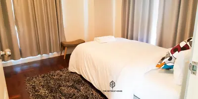 a bedroom with a bed with a white blanket and a rug at The Retreat Ao nang Private Pool Villa in Ao Nang Beach