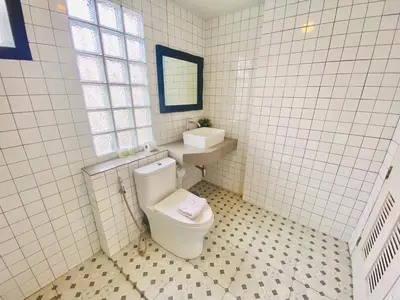a white bathroom with a toilet and a sink at The Retreat Ao nang Private Pool Villa in Ao Nang Beach