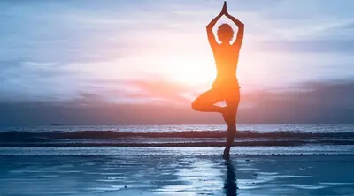 a woman doing a yoga pose on the beach at The Retreat Ao nang Private Pool Villa in Ao Nang Beach