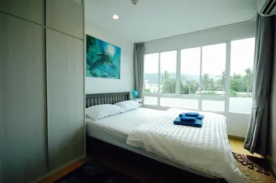 a bedroom with a bed with a large window at Risa Plus in Kathu
