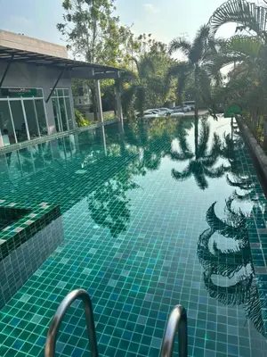 an infinity pool at a resort with palm trees at Phuket naka condon-52-25 \u6cf3\u6c60\u9ad8\u901f\u4e0a\u7f51\u514d\u8d39\u505c\u8f66 in Phuket Town