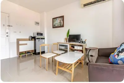 a living room with a couch and a table at Phuket naka condon-52-25 \u6cf3\u6c60\u9ad8\u901f\u4e0a\u7f51\u514d\u8d39\u505c\u8f66 in Phuket Town