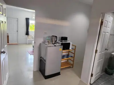 a kitchen with a refrigerator and a stove at Bangtao Mango House in Bang Tao Beach