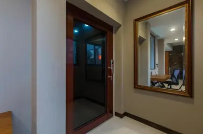 a glass door with a mirror in a room at Aqua A1 in Rawai Beach