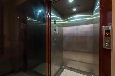 a elevator with a glass door in a building at Aqua A1 in Rawai Beach