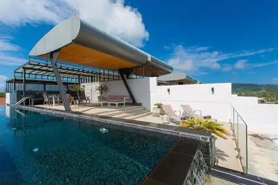 a villa with a swimming pool and a house at Aqua A1 in Rawai Beach