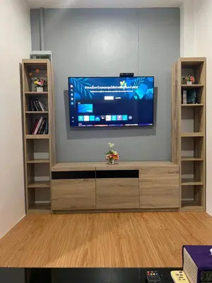 a entertainment center with a flat screen tv on a wall at 65 Pradit in Nai Yang Beach