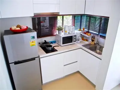 a white kitchen with a refrigerator and a microwave at COCO Chalong 2 bedrooms New Villa in Chalong