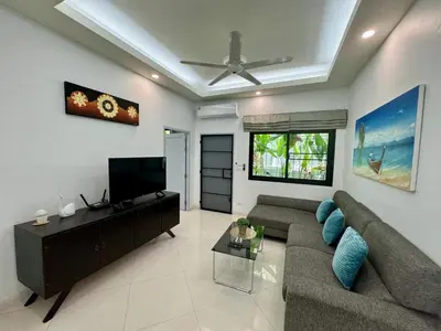 a living room with a couch and a flat screen tv at Gabriel Villa by G Estate in Rawai Beach