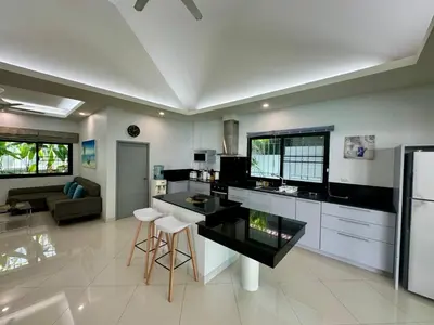 a kitchen with a black counter top in a room at Gabriel Villa by G Estate in Rawai Beach