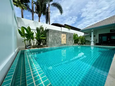 a swimming pool in a villa with palm trees at Gabriel Villa by G Estate in Rawai Beach