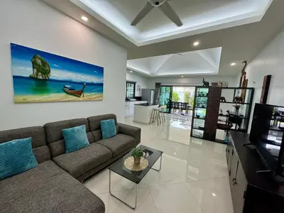 a living room with a couch and a tv at Gabriel Villa by G Estate in Rawai Beach