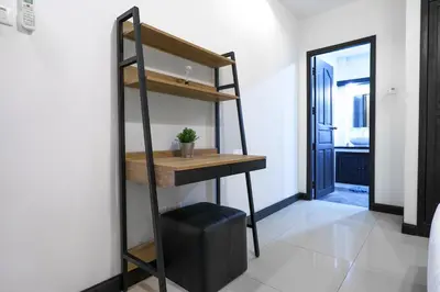 a room with a desk and a shelf and a door at Champagne Villa by G Estate in Rawai Beach