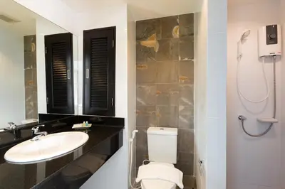 a bathroom with a toilet and a sink at Parida Resort in Bang Tao Beach