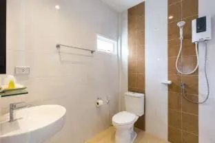 a bathroom with a toilet and a sink and a shower at Parida Resort in Bang Tao Beach