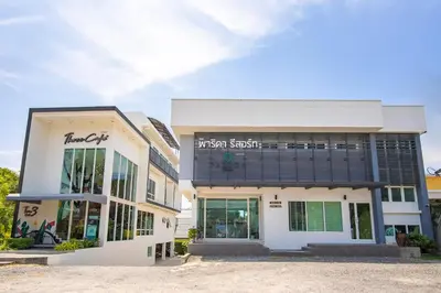 a building with a sign on the front of it at Parida Resort in Bang Tao Beach
