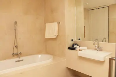 a bathroom with a bath tub and a sink at Baan Mai Khao in Mai Khao Beach