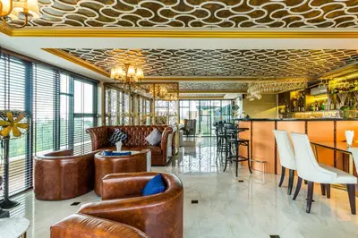 a lobby with leather furniture and a bar at 6th Avenue Surin by Lofty in Surin Beach