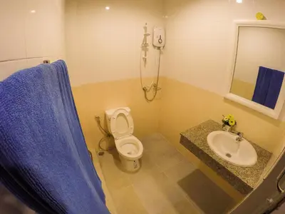 a bathroom with a toilet and a sink and a shower at Madam House in Karon Beach