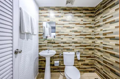 a bathroom with a toilet and a sink at Naiyang Place - Phuket Airport in Nai Yang Beach