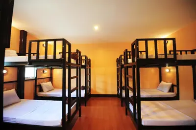 a room with four bunk beds in a room at Twin Palms Hostel Phi Phi in Phi Phi Don